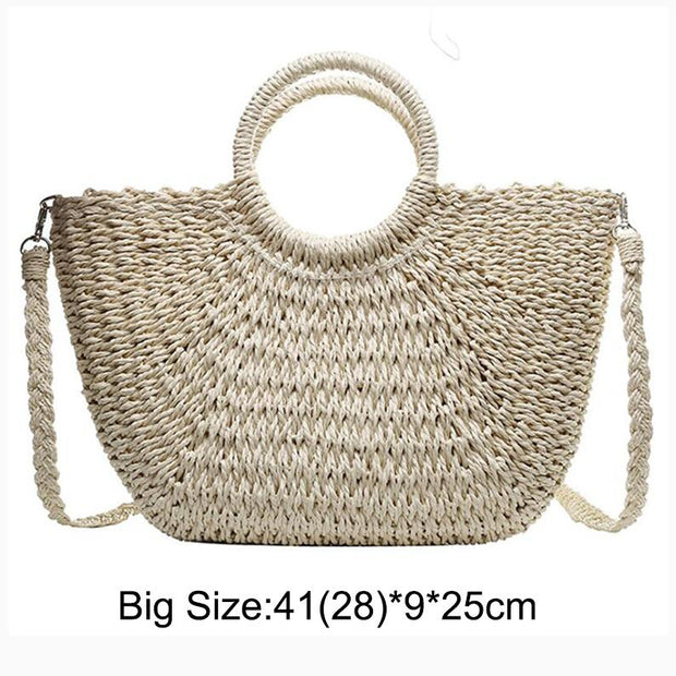 Stylish fancy straw bag with a woven design, colorful tassels, and sturdy leather handles, ideal for fashionable summer outings.