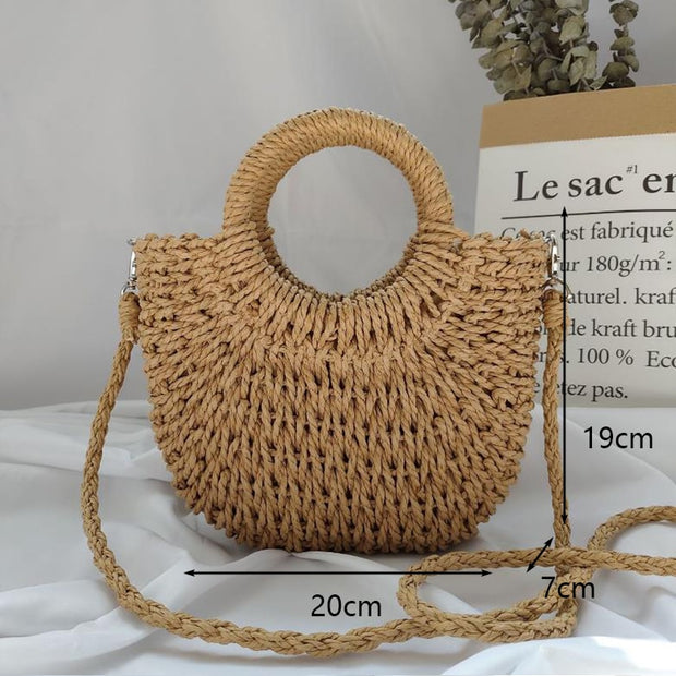 Stylish fancy straw bag with a woven design, colorful tassels, and sturdy leather handles, ideal for fashionable summer outings.