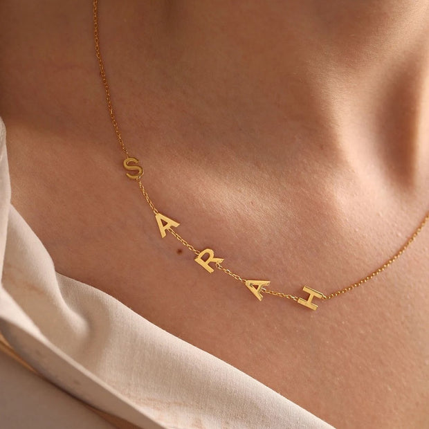 Express your individuality with our custom letter pendant choker name necklace. Featuring personalized letter pendants on a sleek choker chain, this necklace adds a unique and stylish touch to any outfit, perfect for casual and formal occasions.