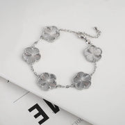 Double-sided plum blossom bracelet featuring intricate blossom designs on both sides, crafted from high-quality materials for a stylish and elegant look. Perfect for adding a unique touch to any outfit.