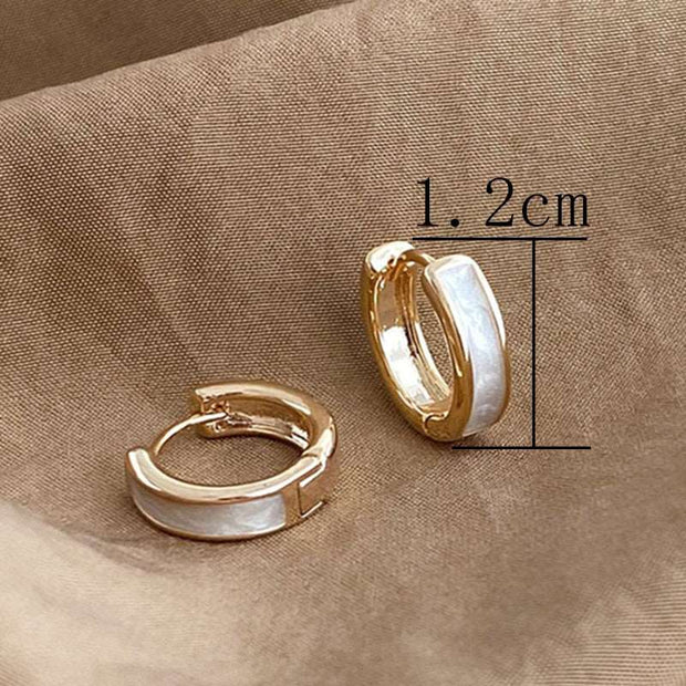 Classic hoop earrings crafted from genuine 14K gold, featuring a timeless and elegant design. Perfect for adding a touch of sophistication to any look, these earrings are a versatile accessory."