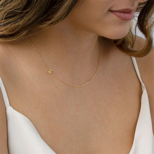 Express your individuality with our custom letter pendant choker name necklace. Featuring personalized letter pendants on a sleek choker chain, this necklace adds a unique and stylish touch to any outfit, perfect for casual and formal occasions.