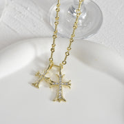 Zircon double cross necklace featuring two interlocking crosses adorned with sparkling zircon stones on a delicate chain, perfect for adding a touch of elegance and faith to any outfit. Suitable for both casual and formal occasions.