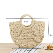 Stylish fancy straw bag with a woven design, colorful tassels, and sturdy leather handles, ideal for fashionable summer outings.