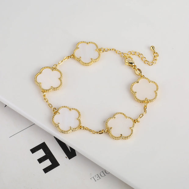 Double-sided plum blossom bracelet featuring intricate blossom designs on both sides, crafted from high-quality materials for a stylish and elegant look. Perfect for adding a unique touch to any outfit.