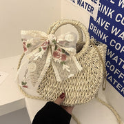 "Lace bow rattan bag: Delicately crafted for timeless charm. Elevate your ensemble with this whimsical yet sophisticated accessory."