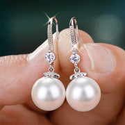 Elegant pearl dangle earrings with silver hooks, perfect for adding sophistication to any outfit. Handcrafted with lustrous pearls, these earrings exude timeless charm and style.