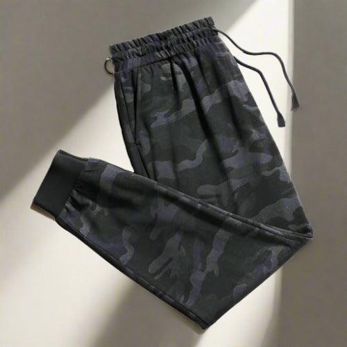 Camouflage drawstring trousers, perfect for a blend of style and utility. Adjustable drawstring waist and durable fabric make these trousers ideal for casual wear and outdoor activities.